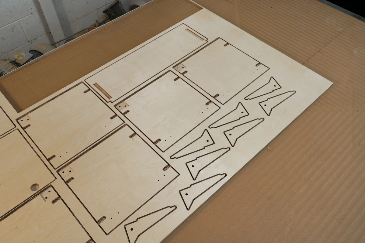 A birch sheet on the cutting bed, maze walls scored and ready to punch out.